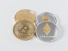 four round silver-colored and gold-colored Bitcoins