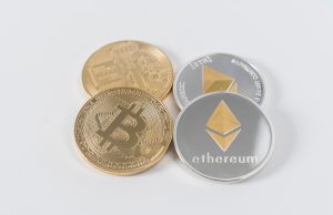 four round silver-colored and gold-colored Bitcoins