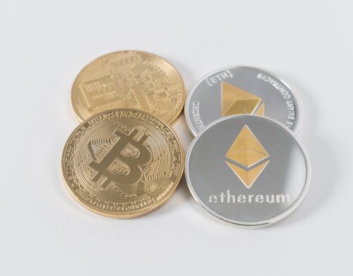 four round silver-colored and gold-colored Bitcoins